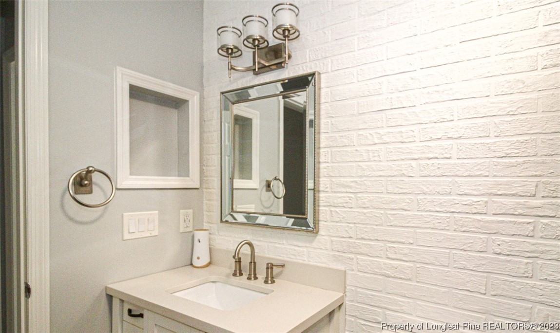 544 Blackbird Road Fayetteville, NC 28314 - Photo 17 of 36 a bathroom with a sink and a mirror