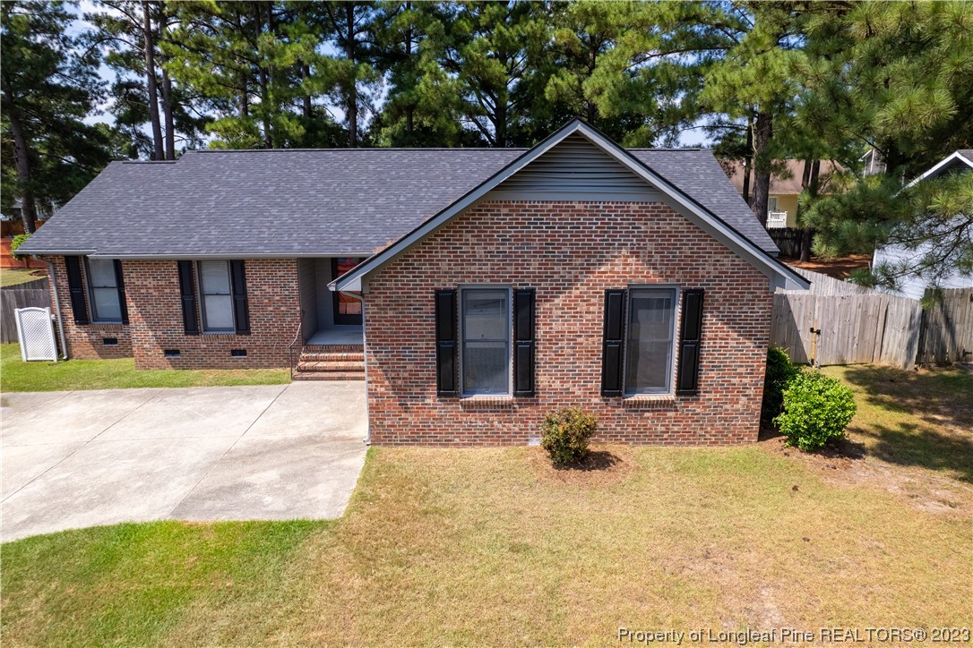 544 Blackbird Road Fayetteville, NC 28314 - Photo 2 of 36 a front view of a house with a yard and garage