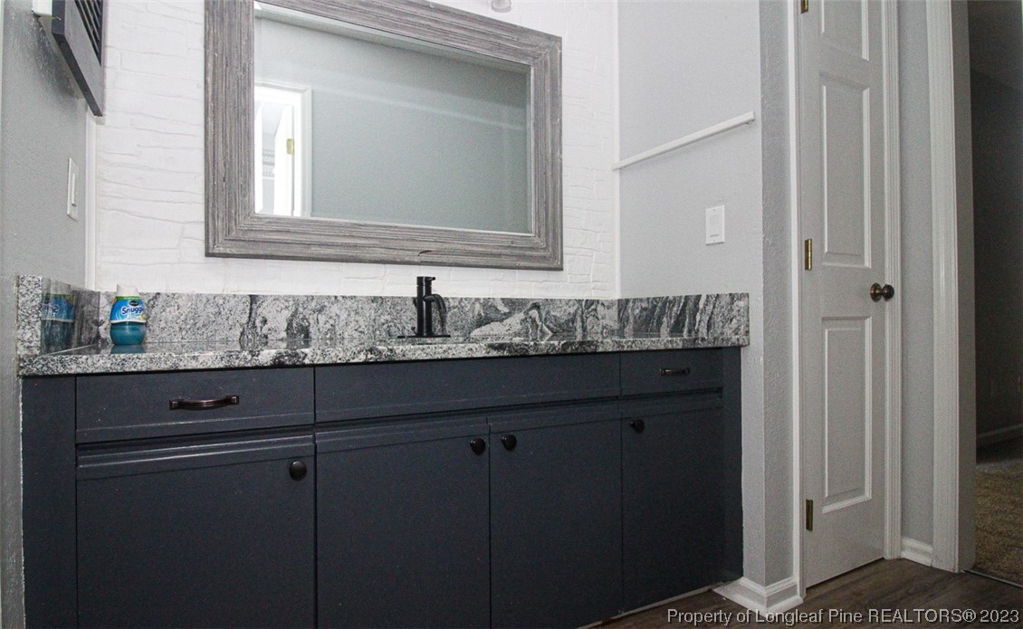 544 Blackbird Road Fayetteville, NC 28314 - Photo 22 of 36 a bathroom with a granite countertop sink and a mirror