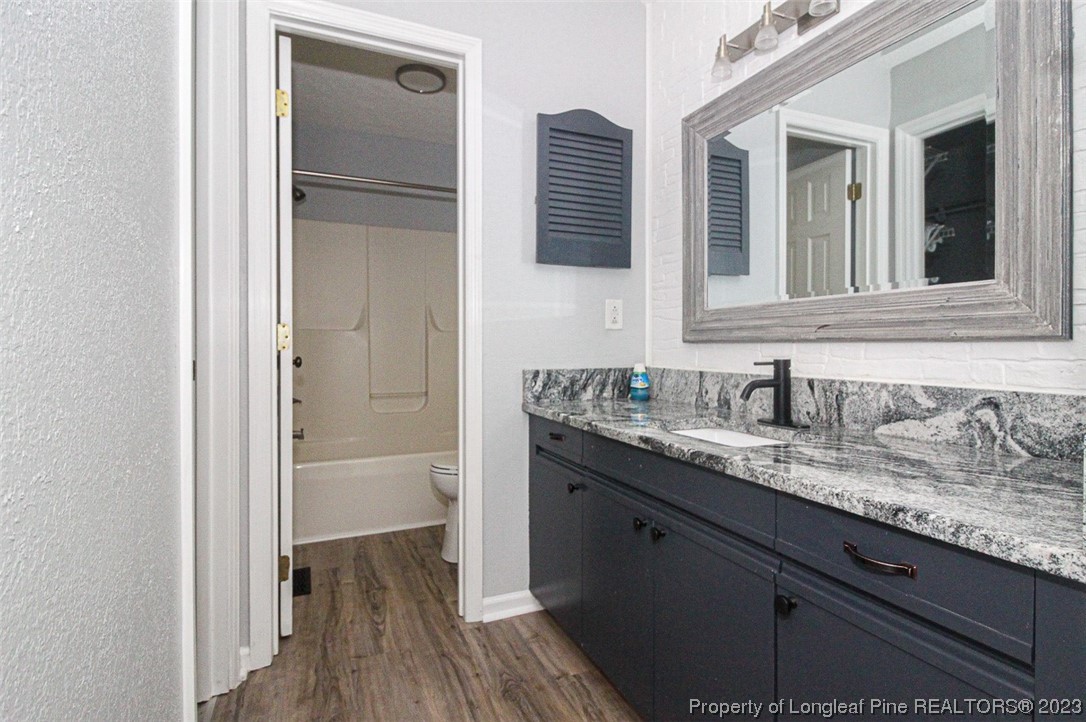 544 Blackbird Road Fayetteville, NC 28314 - Photo 23 of 36 a bathroom with a granite countertop sink and a mirror
