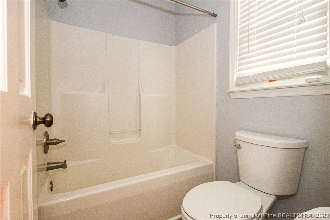 544 Blackbird Road Fayetteville, NC 28314 - Photo 24 of 36 a white toilet sitting next to a bath tub