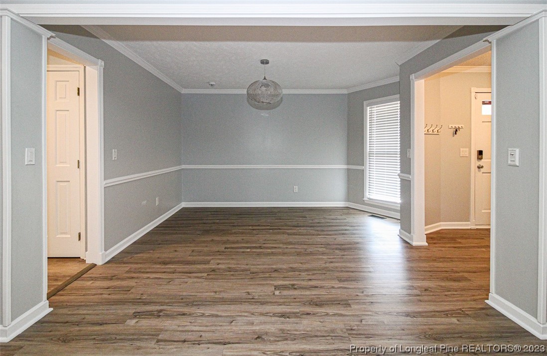 544 Blackbird Road Fayetteville, NC 28314 - Photo 8 of 36 a view of an empty room with wooden floor and a window