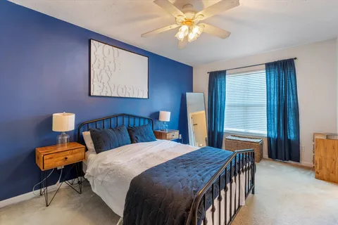 a bedroom with a bed and a chandelier