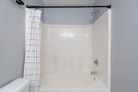 a bathroom with a shower and a bathtub
