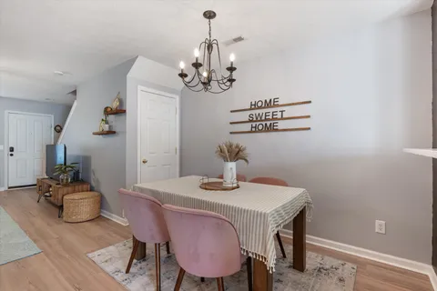 a view of a dining room with furniture and wooden floor