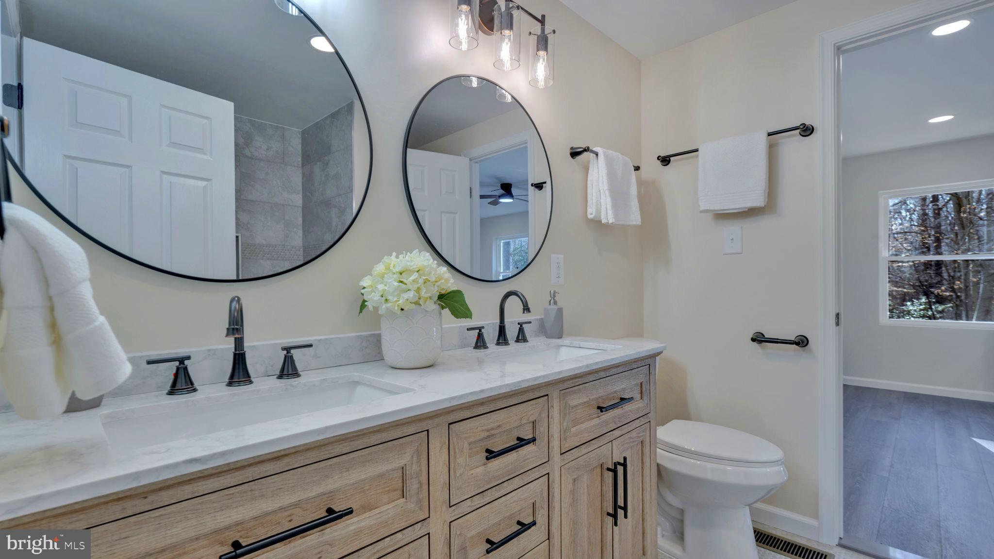 10965 La Plata Road La Plata, MD 20646 - Photo 13 of 24 a bathroom with a double vanity sink and a mirror