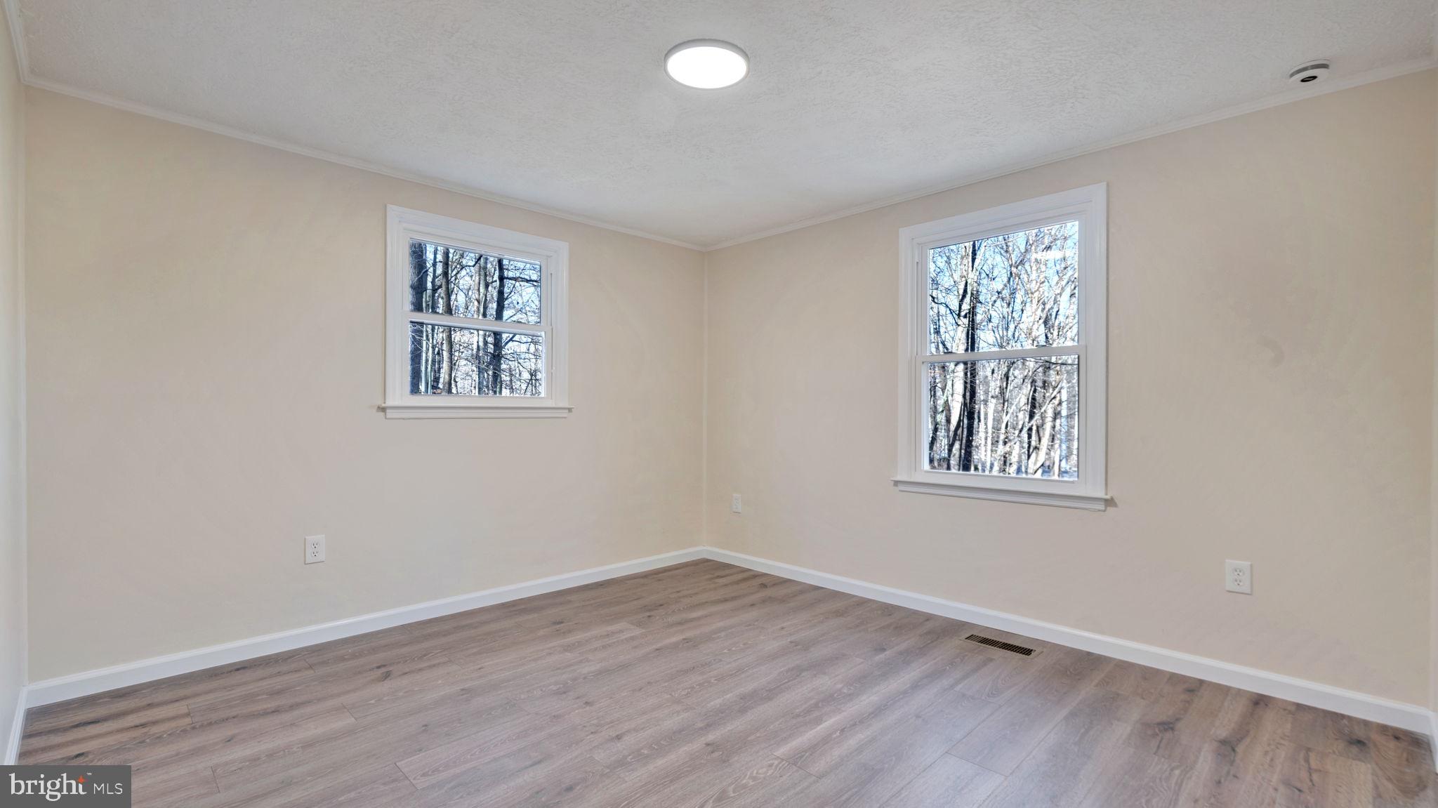 10965 La Plata Road La Plata, MD 20646 - Photo 19 of 24 a view of an empty room with wooden floor and a window