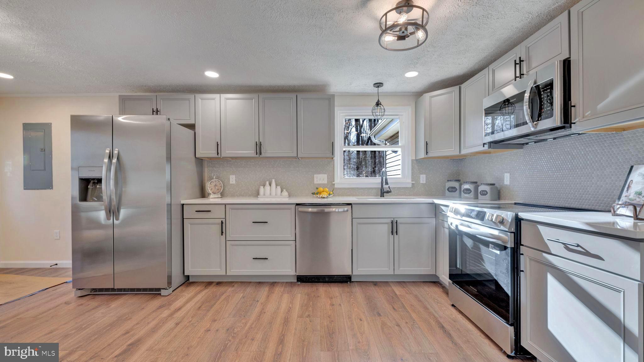 10965 La Plata Road La Plata, MD 20646 - Photo 9 of 24 a kitchen with stainless steel appliances granite countertop a stove a sink and a refrigerator