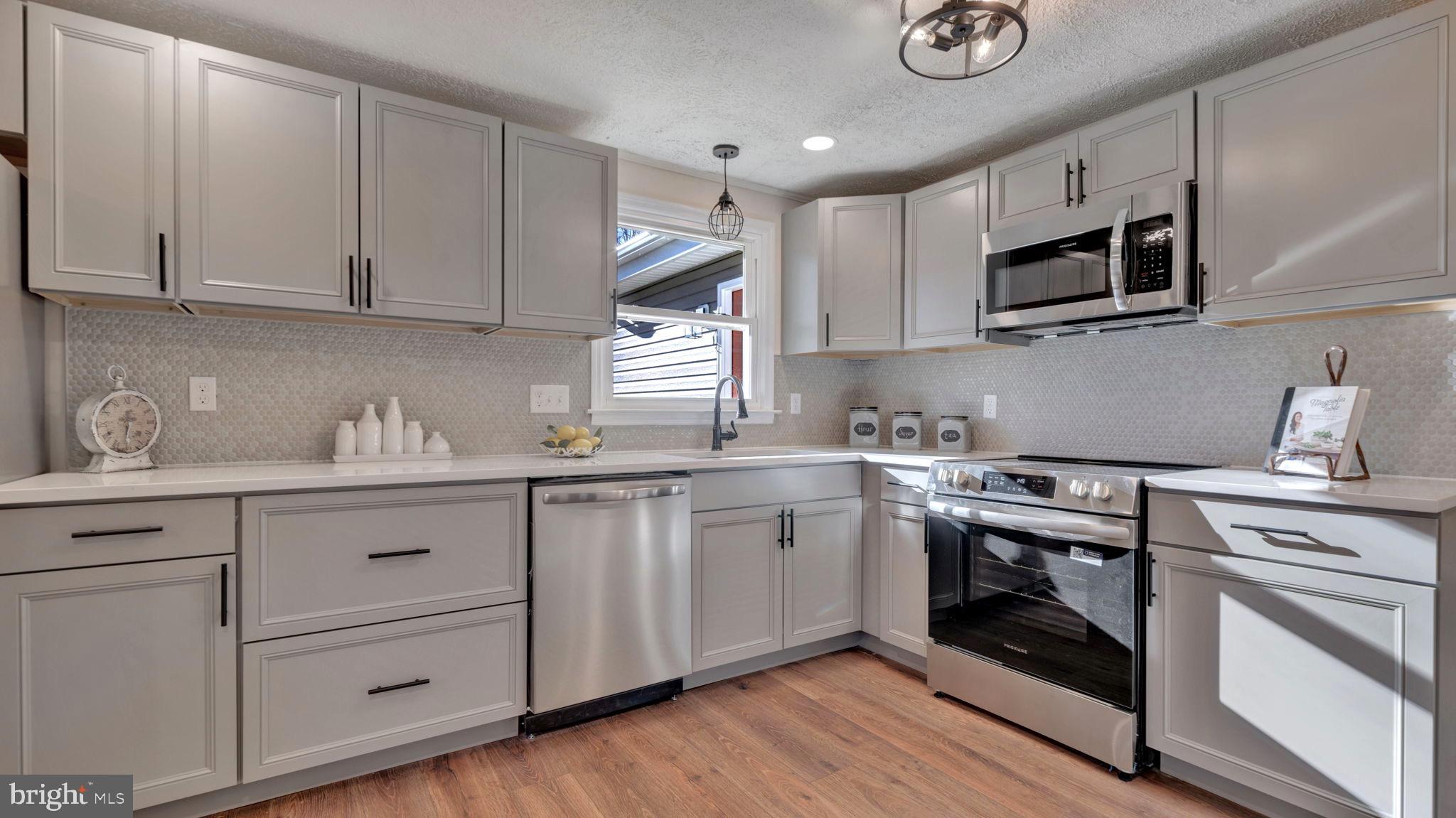 10965 La Plata Road La Plata, MD 20646 - Photo 10 of 24 a kitchen with granite countertop white cabinets stainless steel appliances and sink