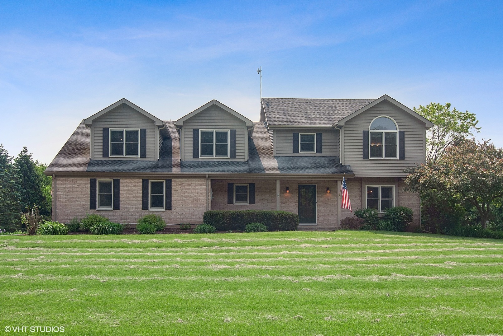 a front view of a house with a garden