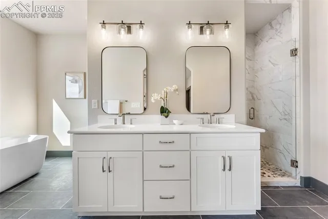 a bathroom with double vanity sinks and a mirror