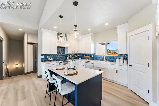 a large kitchen with a table and chairs