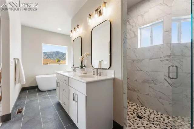 a bathroom with a double vanity sink and a mirror