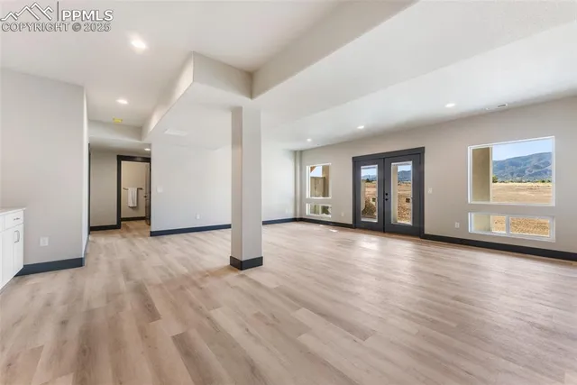 a view of a livingroom with wooden floor and window