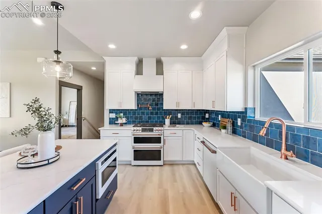 a kitchen with a sink stove and cabinets