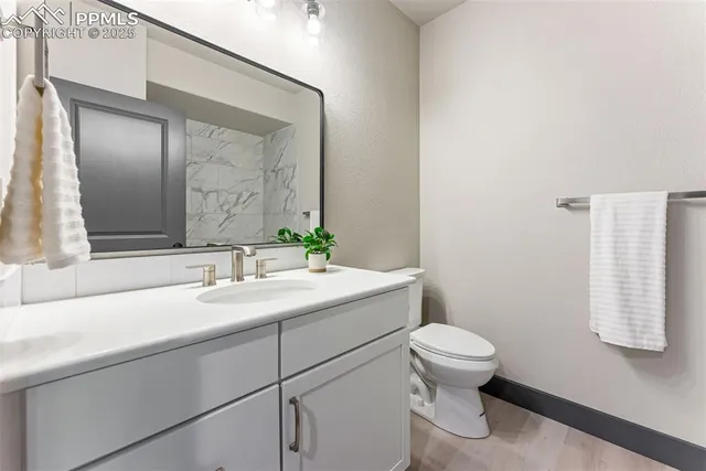 a bathroom with a sink toilet and mirror