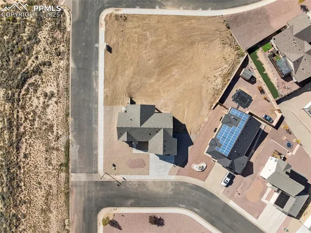 an aerial view of house with yard