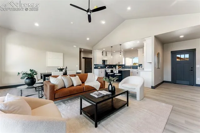 a living room with furniture and kitchen view