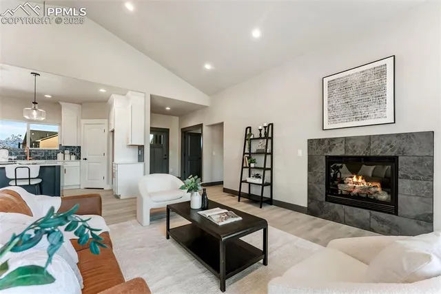 a living room with furniture and a fireplace