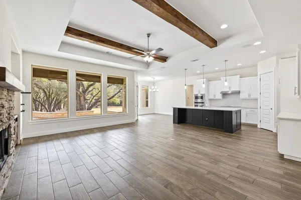 a view of kitchen with stove and cabinets