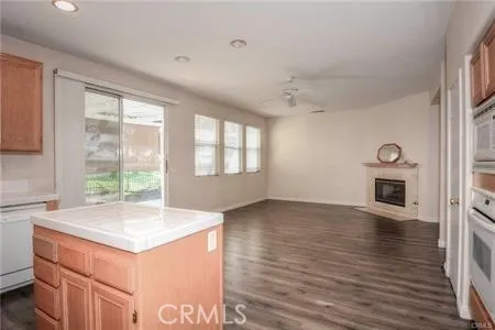 a view of kitchen with wooden floor and electronic appliances
