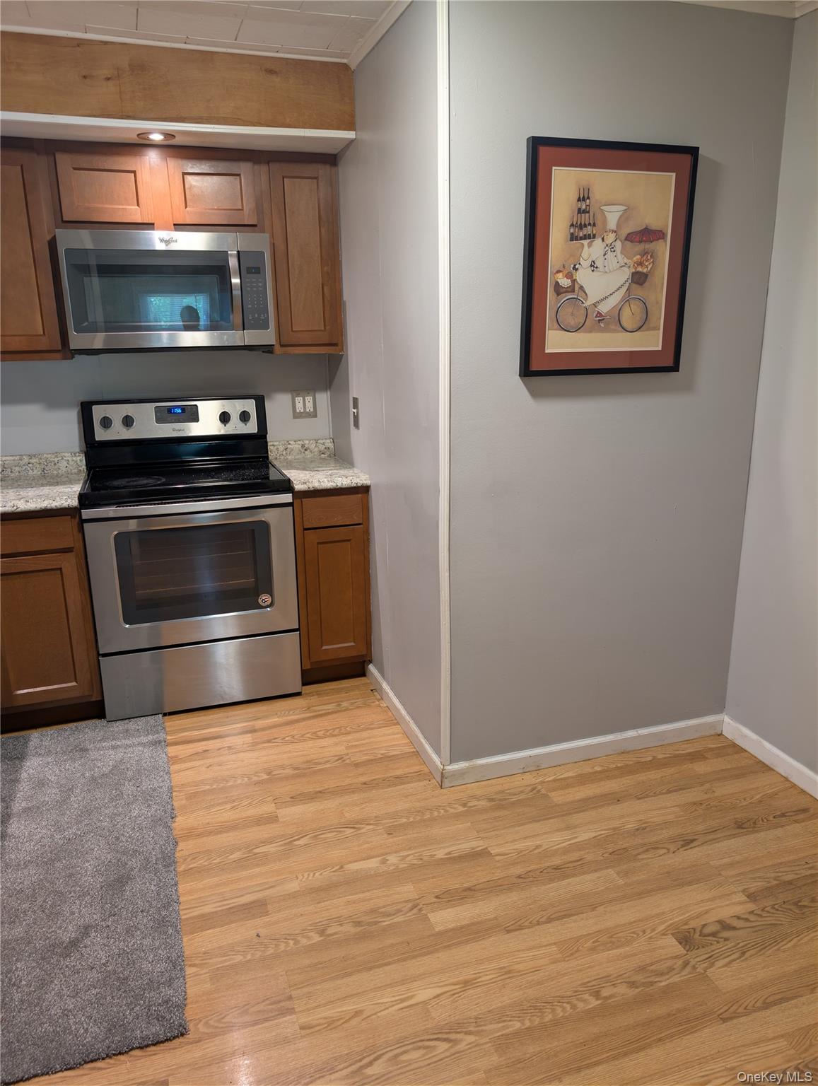 394 Riley Road, Unit 1 New Windsor, NY 12553 - Photo 10 of 24 Kitchen space features wood-finish flooring and light gray walls, stainless steel appliances and eating area