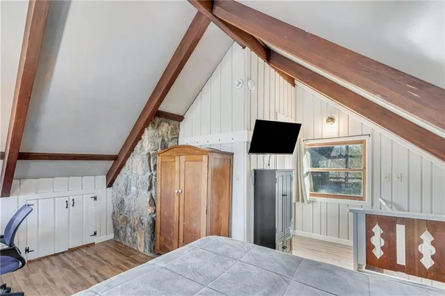 a bedroom with two beds and a chandelier