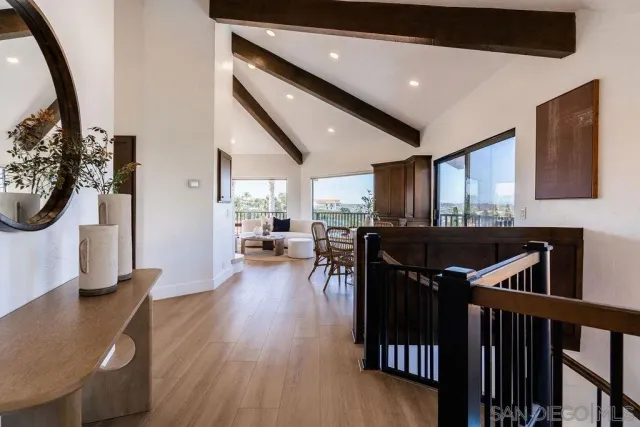 a living room with furniture wooden floor and a large window