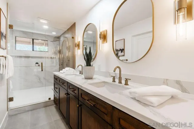 a living room with couches and dining table with wooden floor