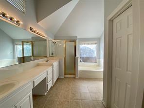 3169 Riverside Drive Carrollton, TX 75007 - Photo 11 of 16 a large bathroom with a glass shower door and a sink