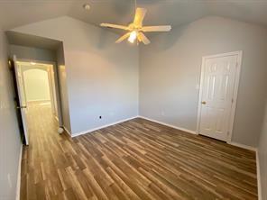 3169 Riverside Drive Carrollton, TX 75007 - Photo 14 of 16 a view of a room with wooden floor and a ceiling fan