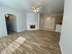3169 Riverside Drive Carrollton, TX 75007 - Photo 16 of 16 a view of a livingroom with a ceiling fan and wooden floor