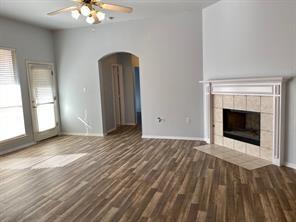 3169 Riverside Drive Carrollton, TX 75007 - Photo 2 of 16 a view of an empty room with window and wooden floor