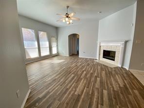 3169 Riverside Drive Carrollton, TX 75007 - Photo 3 of 16 a view of an empty room with a fireplace and a window