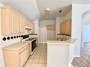 3169 Riverside Drive Carrollton, TX 75007 - Photo 4 of 16 a kitchen with stainless steel appliances a sink a stove a refrigerator and cabinets