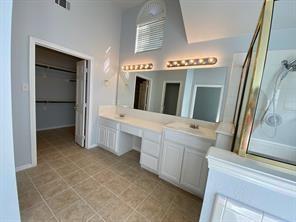 3169 Riverside Drive Carrollton, TX 75007 - Photo 10 of 16 a spacious bathroom with a double vanity sink and a mirror