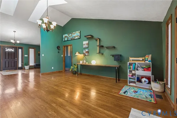 a view of a livingroom with furniture wooden floor and windows