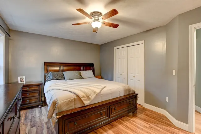 a bedroom with a bed and a ceiling fan