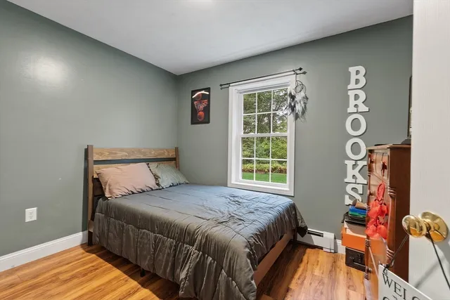 a bed sitting in a bedroom next to a window