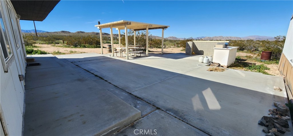 6042 Milne Road Landers, CA 92285 - Photo 9 of 22 Patio concrete and cover