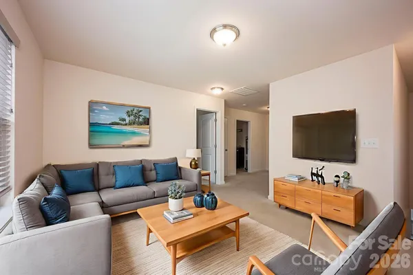 a living room with furniture and a flat screen tv