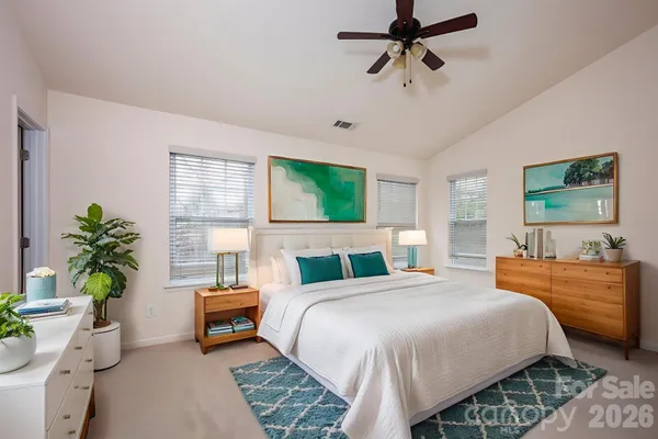 a bedroom with a bed couch and window
