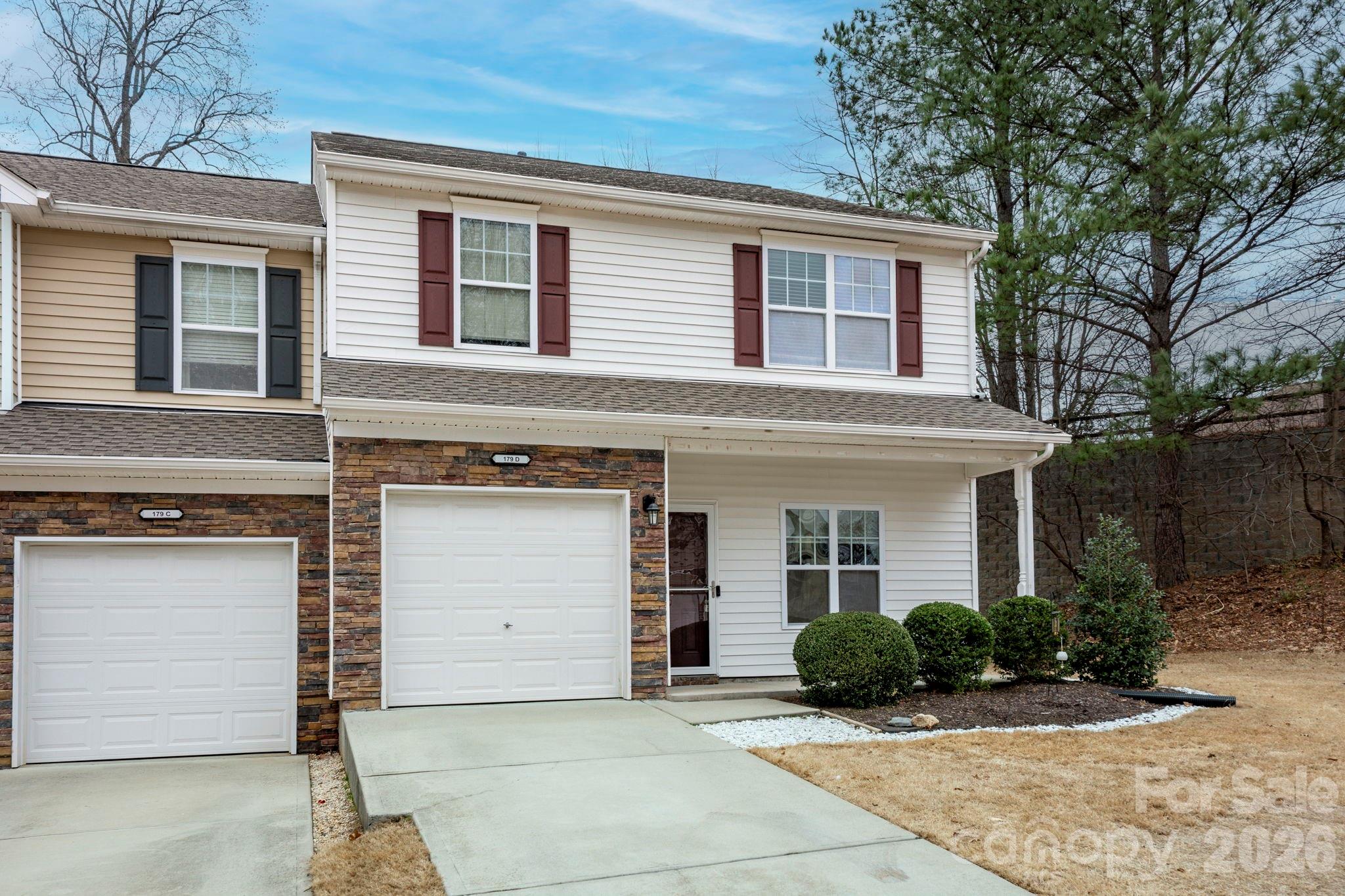179 Limerick Road, Unit D Mooresville, NC 28115 - Photo 2 of 21 a front view of a house with a yard and potted plants