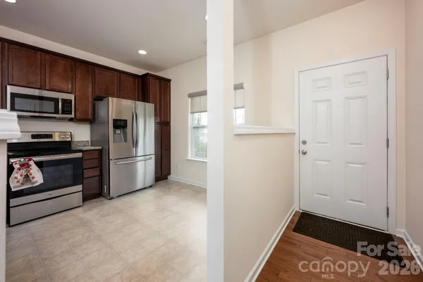 a kitchen with a refrigerator and a stove
