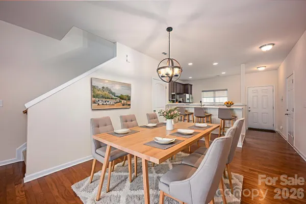 a dining room with furniture a rug and wooden floor