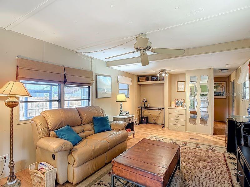 8145 Campbell Court New Port Richey, FL 34653 - Photo 12 of 34 a living room with furniture a ceiling fan and a window