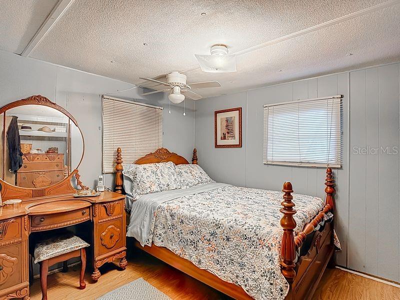 8145 Campbell Court New Port Richey, FL 34653 - Photo 15 of 34 a bedroom with a bed and a dresser