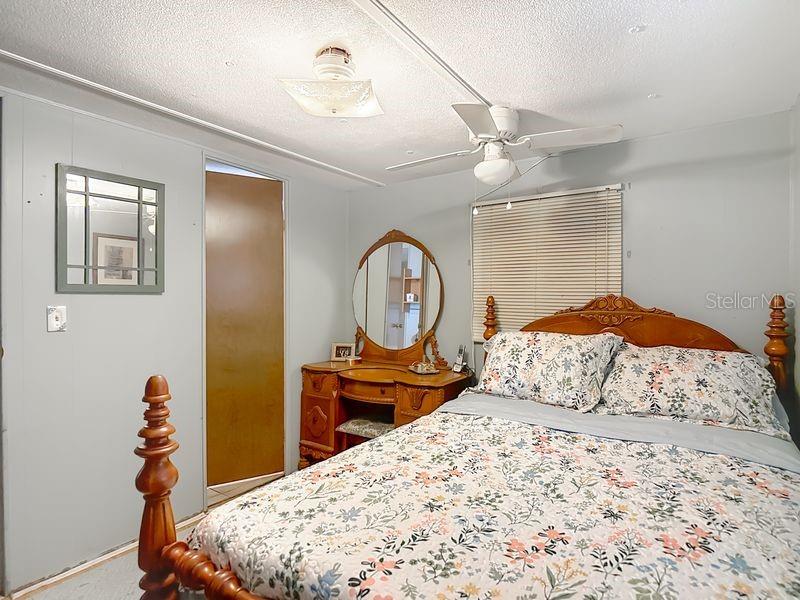 8145 Campbell Court New Port Richey, FL 34653 - Photo 16 of 34 a bedroom with a bed and a dresser