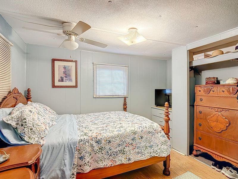 8145 Campbell Court New Port Richey, FL 34653 - Photo 17 of 34 a bedroom with a bed and wooden floor