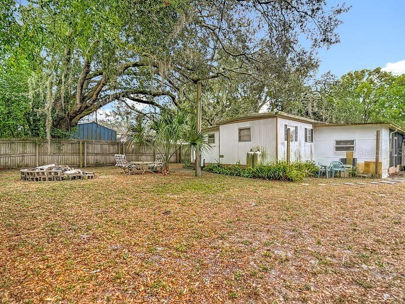 8145 Campbell Court New Port Richey, FL 34653 - Photo 25 of 34 a backyard of a house with table and chairs
